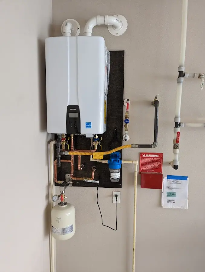 Professional plumber installing copper piping in a Frisco home